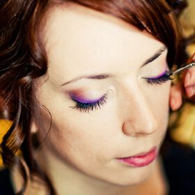 Woman receiving makeup application, Viasun cosmetics theme