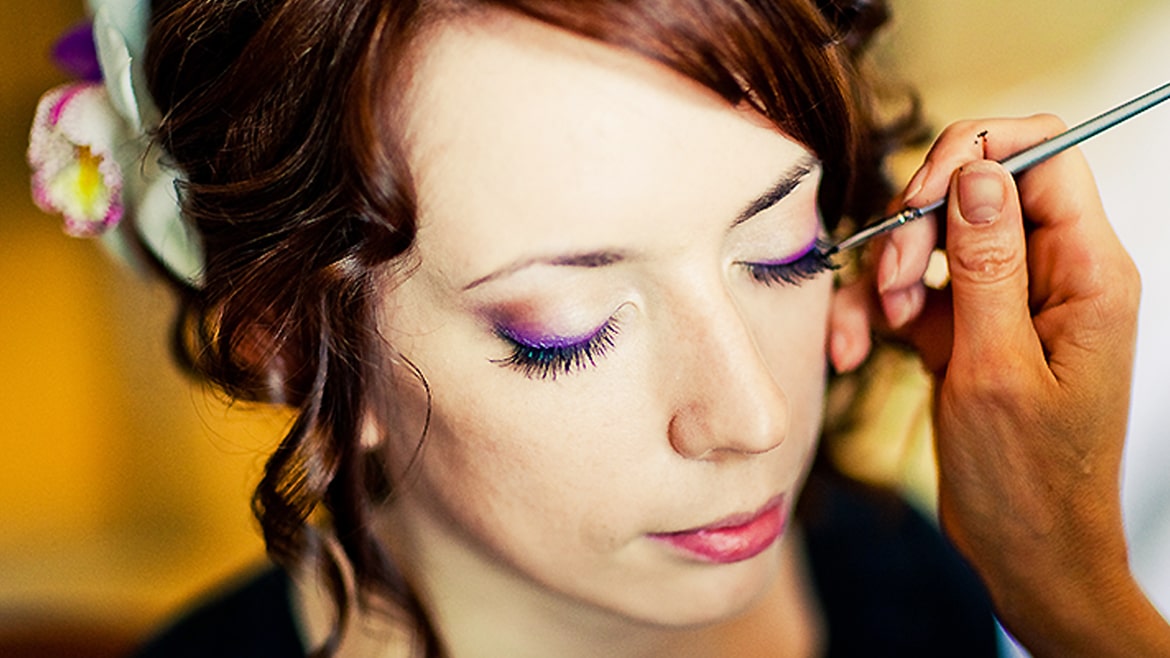 Woman receiving makeup application, Viasun cosmetics theme