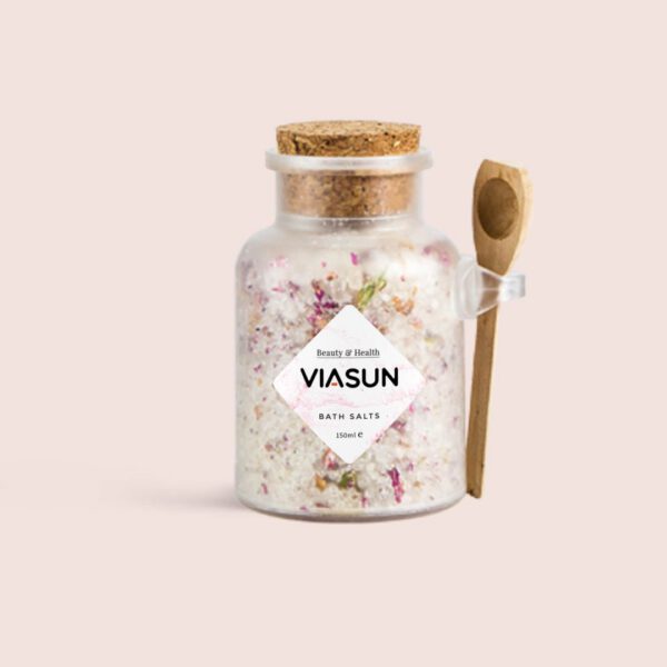 Viasun bath salts in a glass jar with cork lid and wooden spoon.