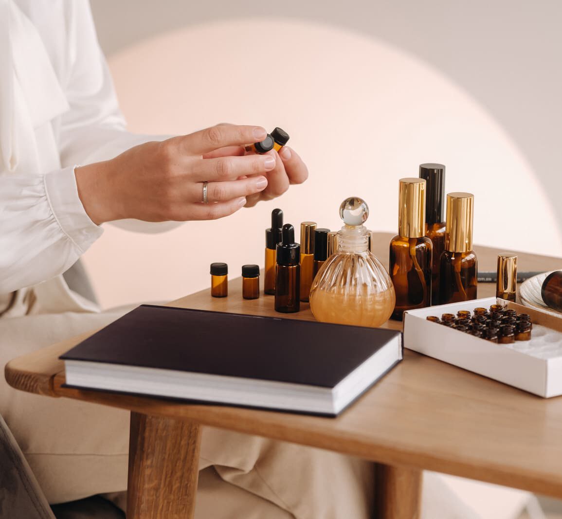 Viasun cosmetics displayed on a table with a person holding a bottle.