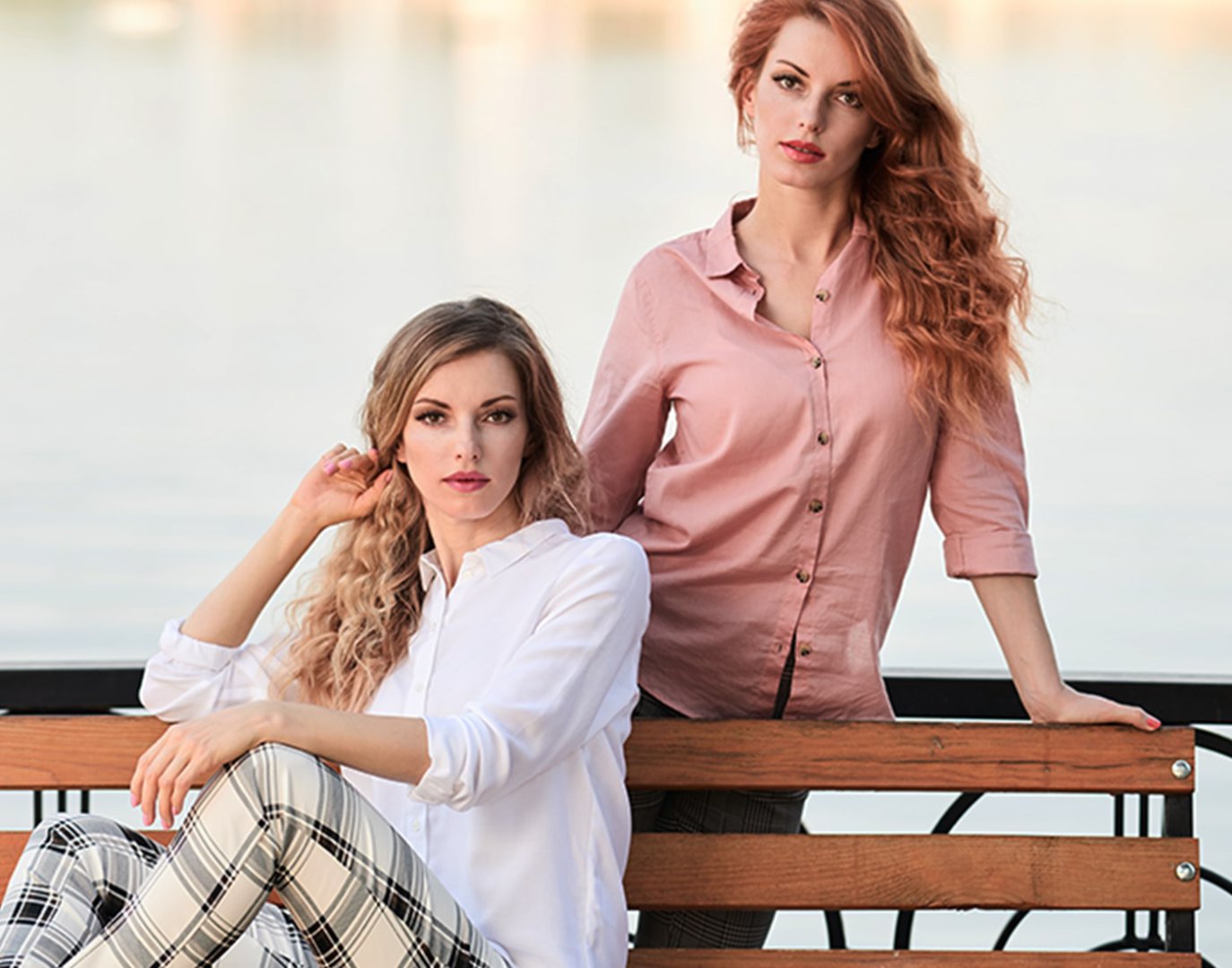 Two women posing by a lake, showcasing Viasun cosmetics theme.