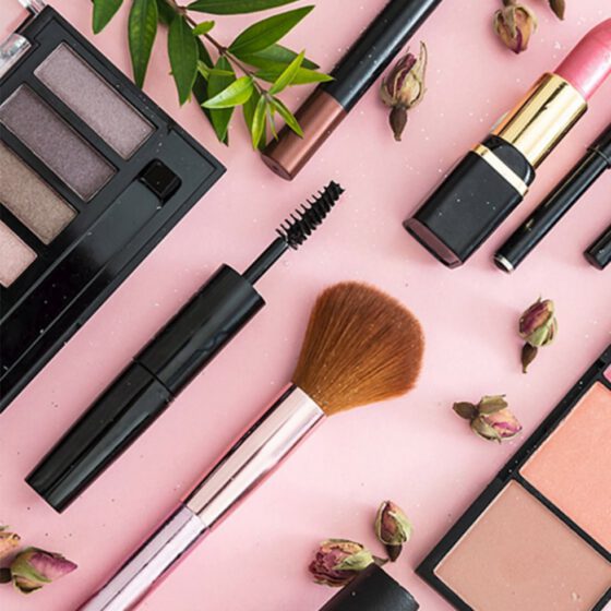 Viasun cosmetics theme with makeup items on pink background